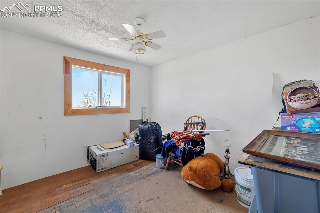 ADU Misc room featuring ceiling fan and a textured ceiling