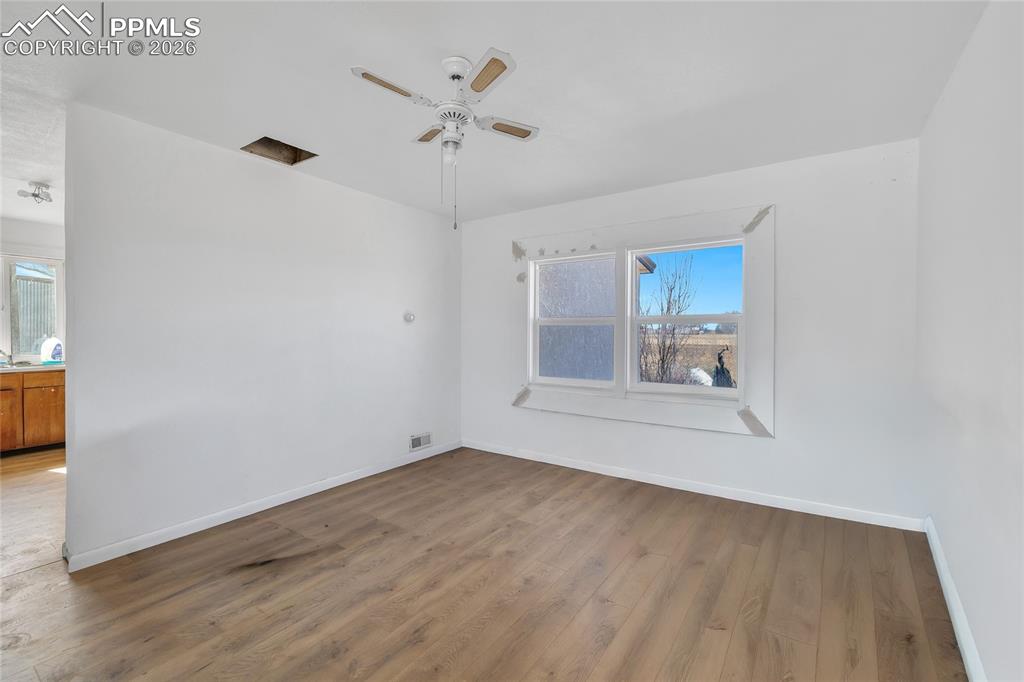 ADU Empty room with wood finished floors and ceiling fan