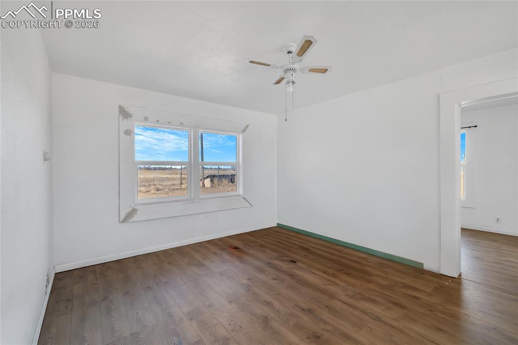 ADU Unfurnished room with dark wood-style flooring and ceiling fan