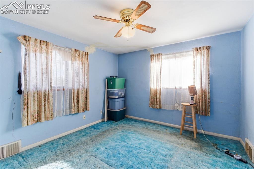 Spare room with a ceiling fan and carpet