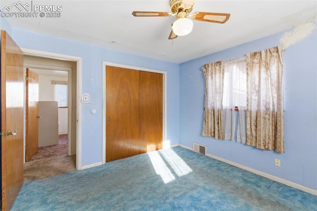 Unfurnished bedroom featuring a closet, ceiling fan, and carpet floors
