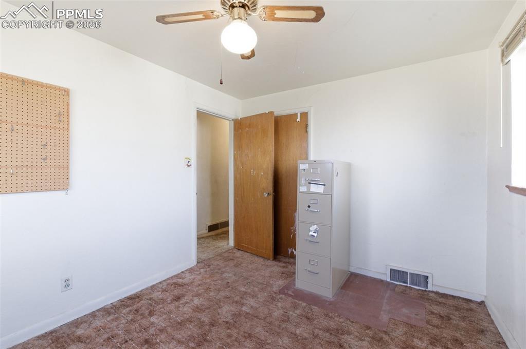 Unfurnished bedroom with carpet floors and ceiling fan