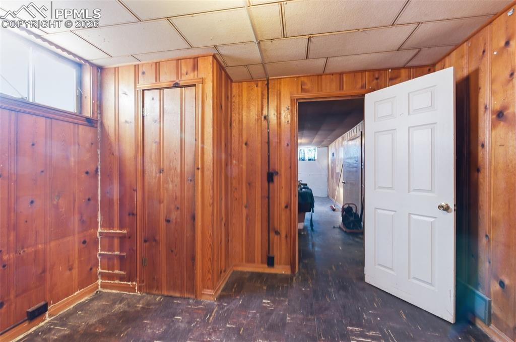 Corridor featuring wood walls and baseboards