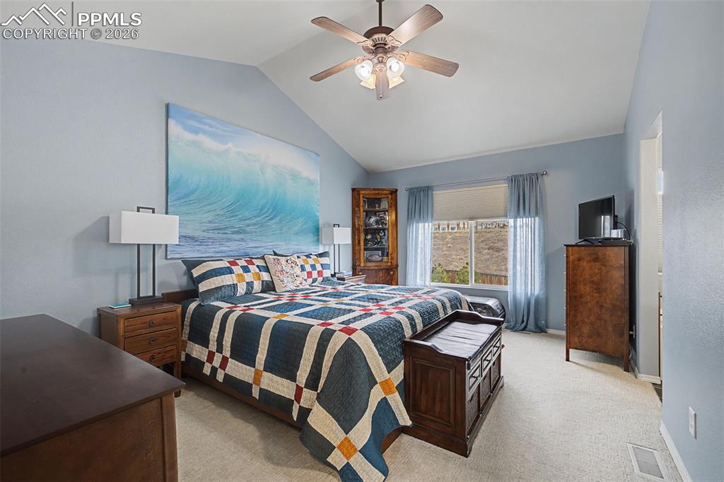 Primary bedroom with vaulted ceilings and attached bath and walk in closet!