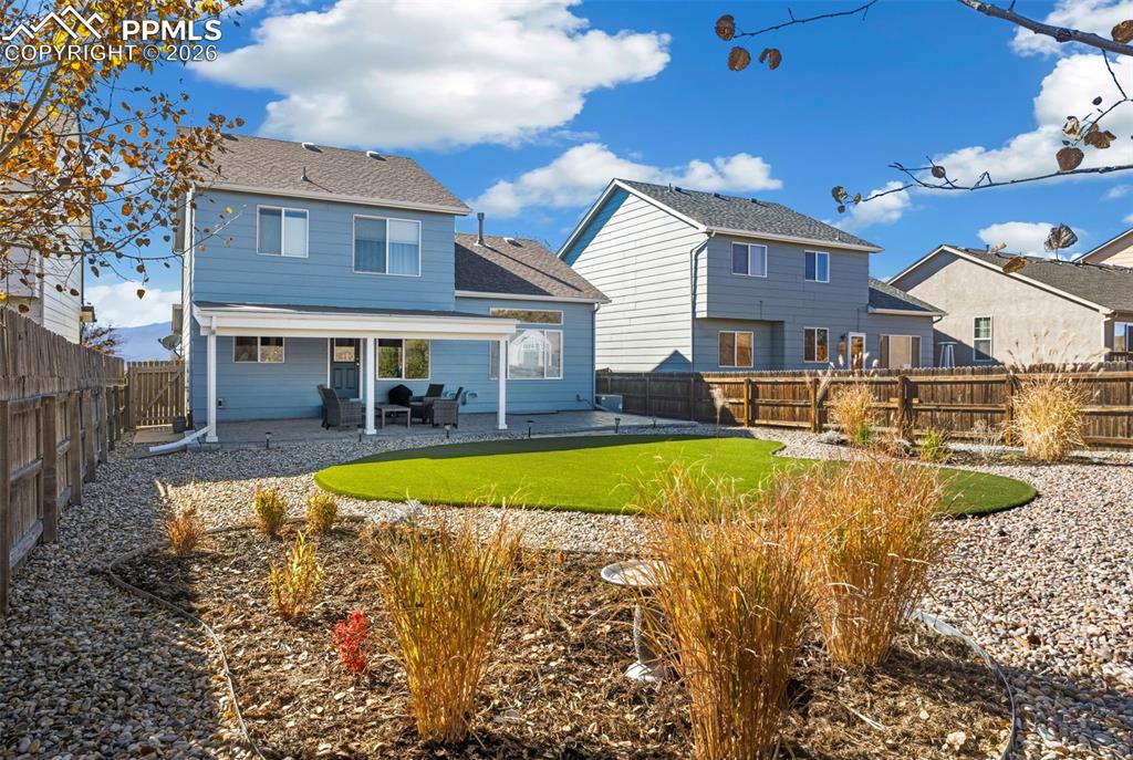 Custom Landscaping with high quality turf and covered patio!