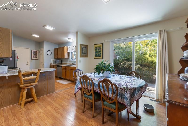 Dining area with light wood finished floors