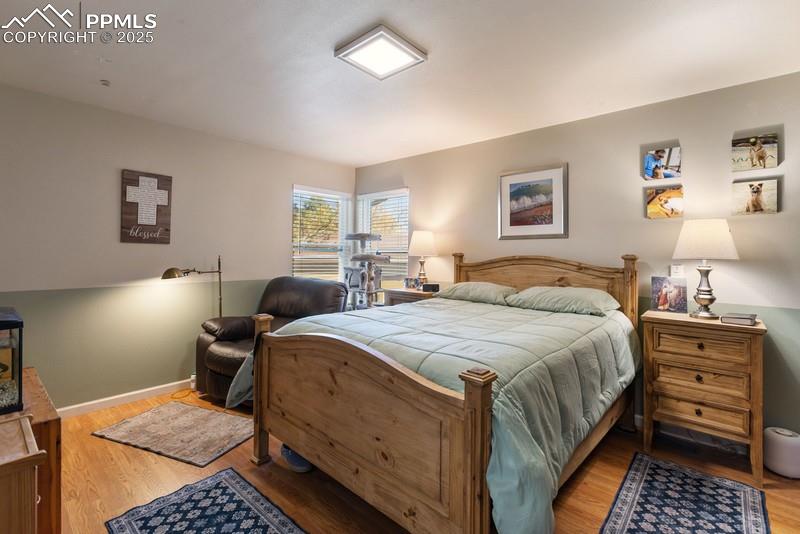 Bedroom with light wood-type flooring and baseboards