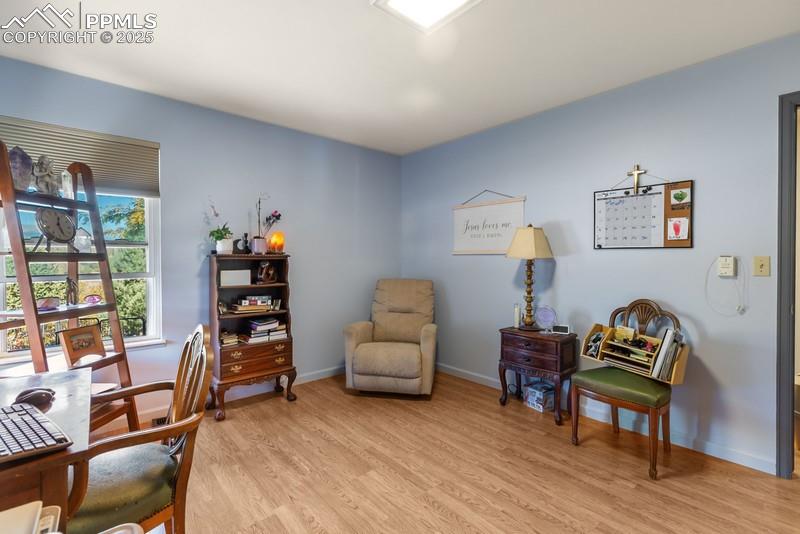 Home office with light wood-style floors and baseboards