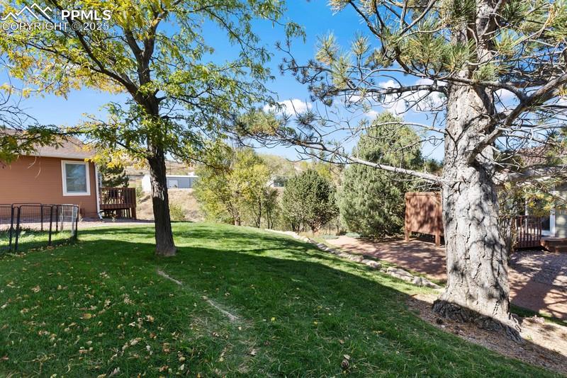 View of yard with a wooden deck