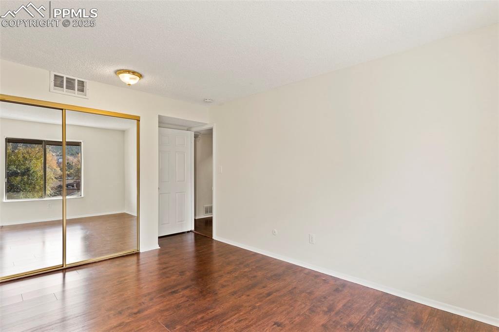 Primary bedroom with glass door closets
