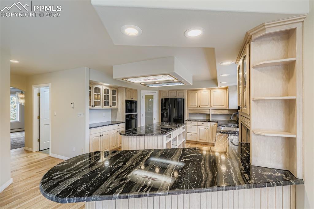 Kitchen with open shelves, wood cabinets, recessed lighting, light wood refinished floors (main floor)