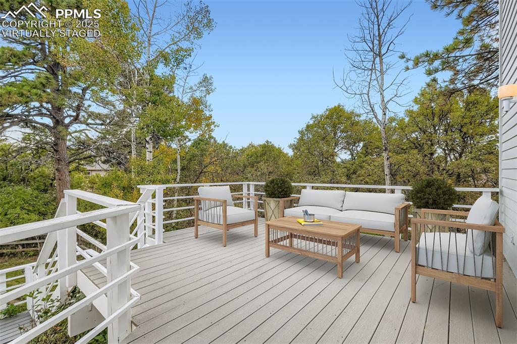 Virtually Staged! Deck in the back (composite) with view of wooded area (walkout from kitchen/living room on main floor)