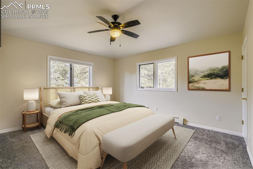 Virtually Staged! Bedroom featuring multiple windows, new carpet, and a ceiling fan, ensuite bathroom (upper level)