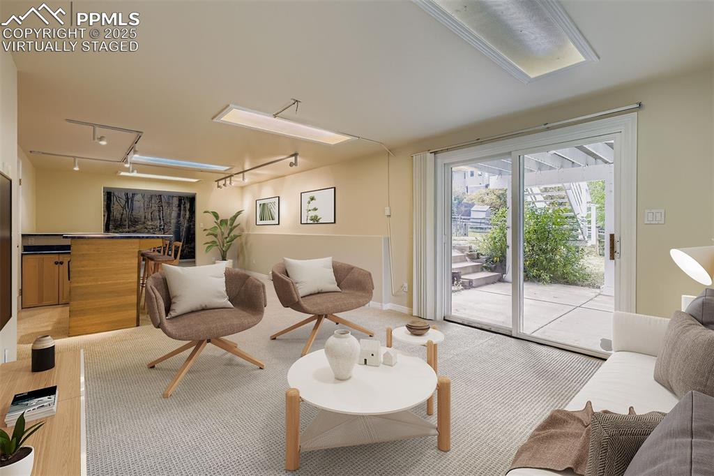 Virtually Staged! 
Family/Recreation  room in basement with rail lighting, light carpet, bathroom on same level, walkout to back yard.