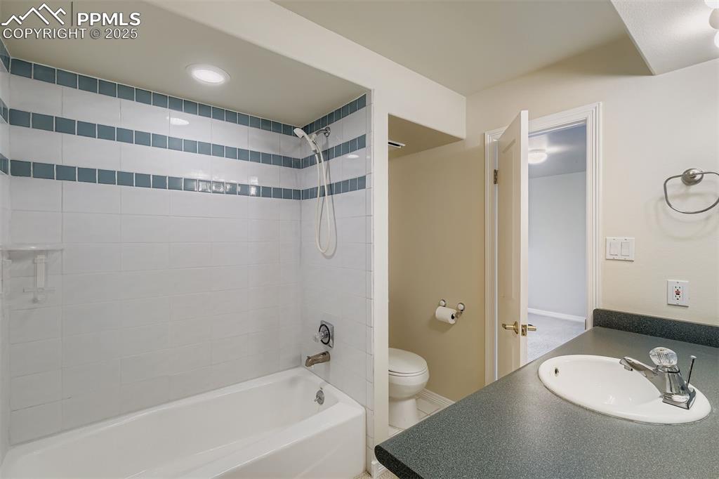 Full bath with shower / bathtub combination, vanity, and recessed lighting