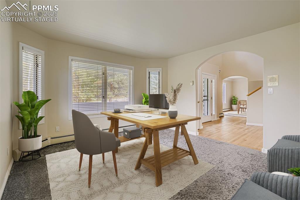 Virtually Staged! Office featuring arched walkways and baseboard heating (main floor)