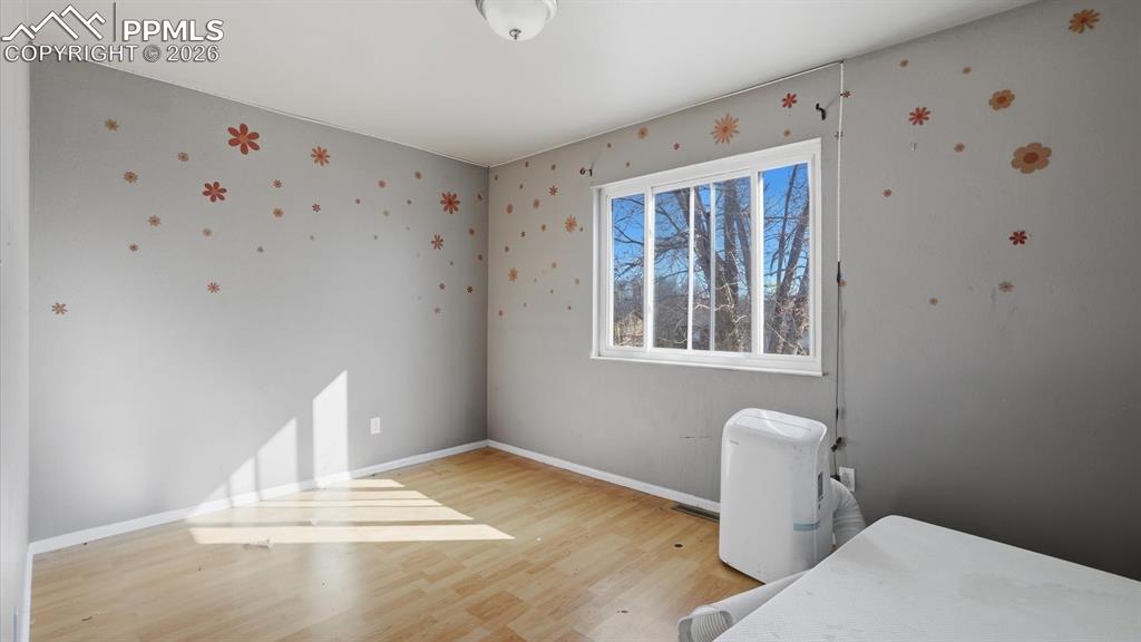 Upper Level Primary Bedroom with wood laminate floor.