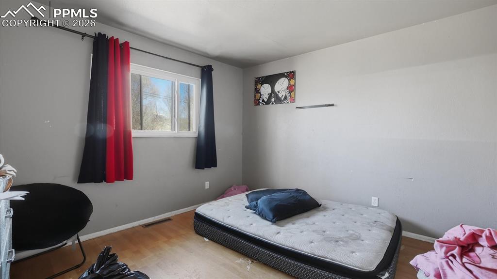 Bedroom #2 has wood laminate flooring and window.