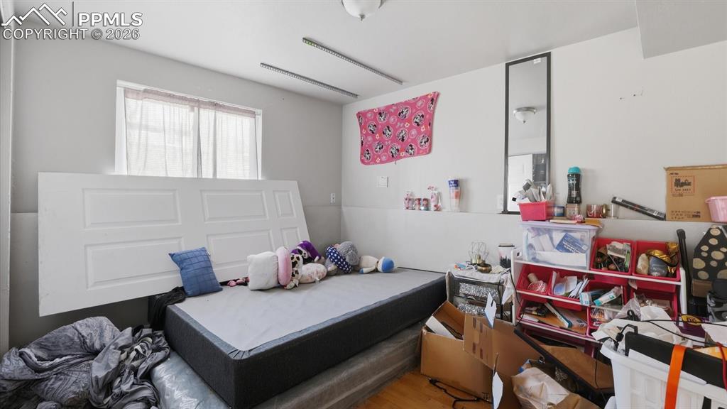 Lower Level Bedroom #4 has wood laminate flooring and a window.