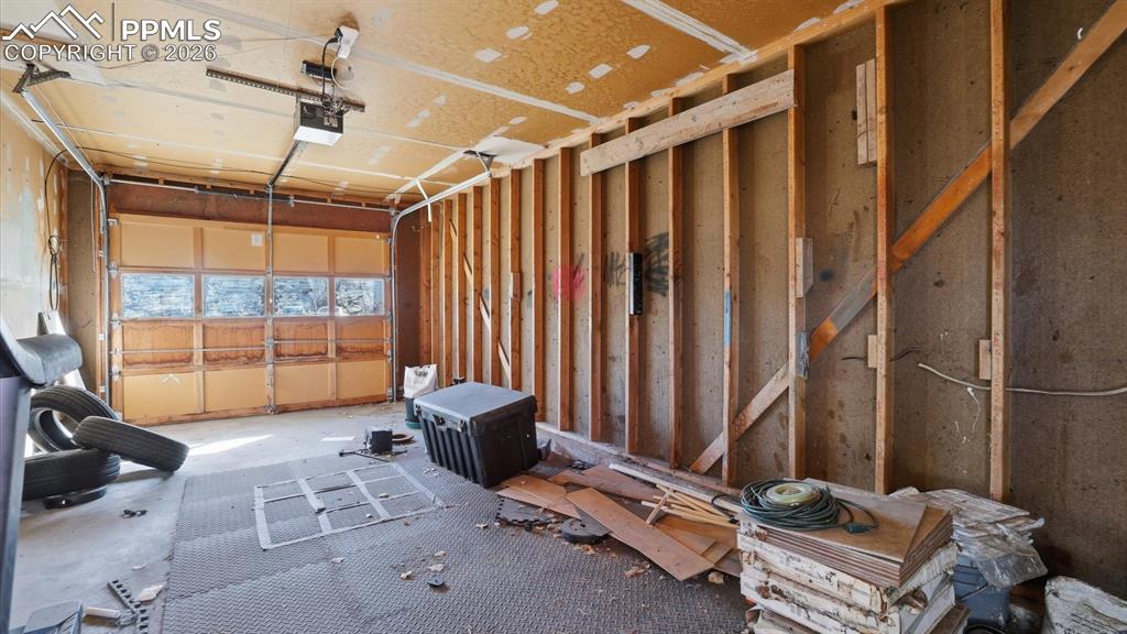 Interior of 1-car attached garage with door opener.