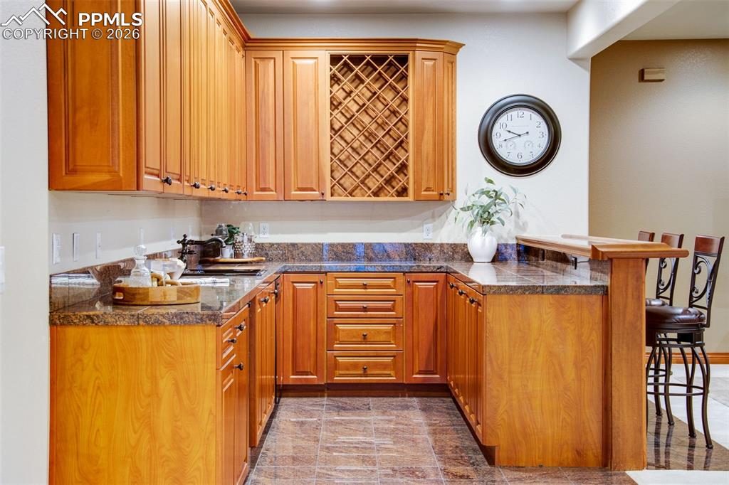 Bar area in the basement level complete with dishwasher and mini fridge 