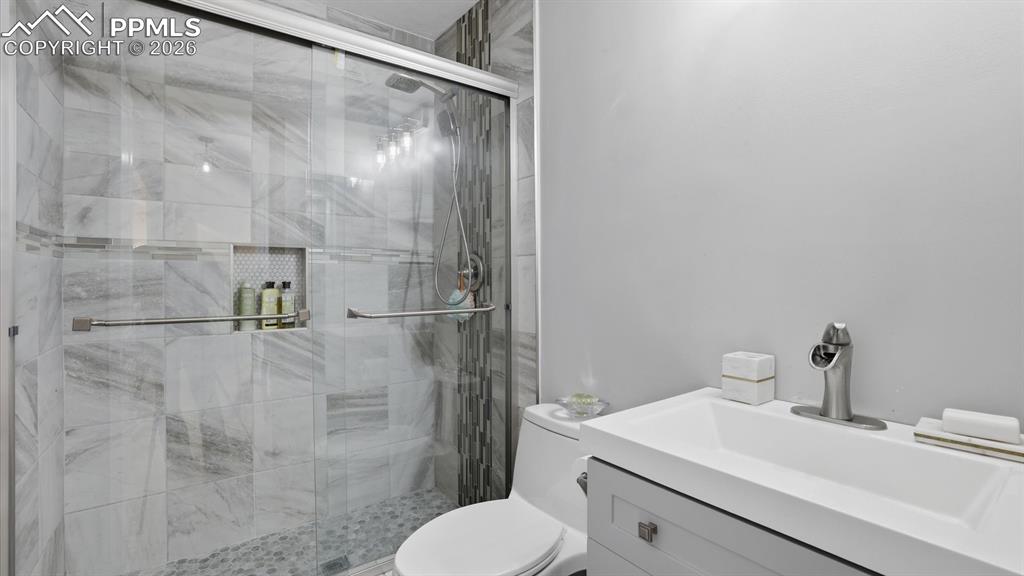 Upper Level Shower Bathroom with vanity, and enclosed tiled shower.