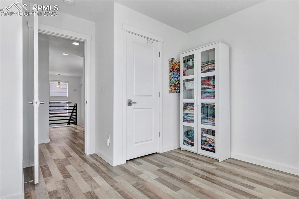 Bedroom - LVP floors, Zebra window coverings, view of Pikes Peak