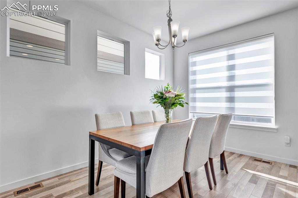 Dining area - LVP flooring, Zebra window coverings