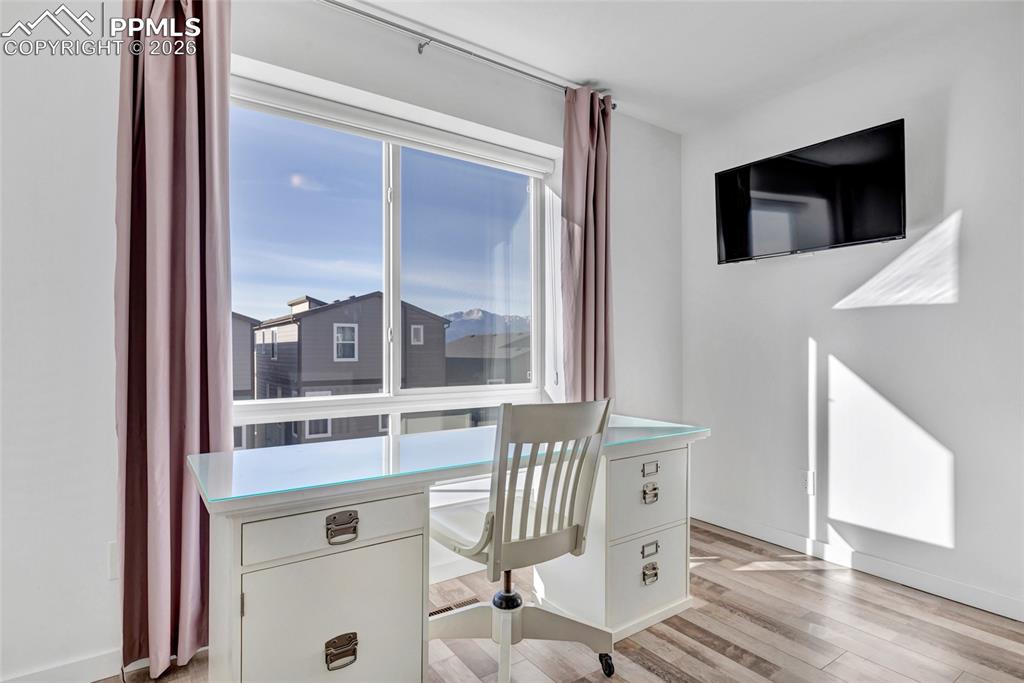 Bedroom - LVP floors, Zebra window coverings, view of Pikes Peak