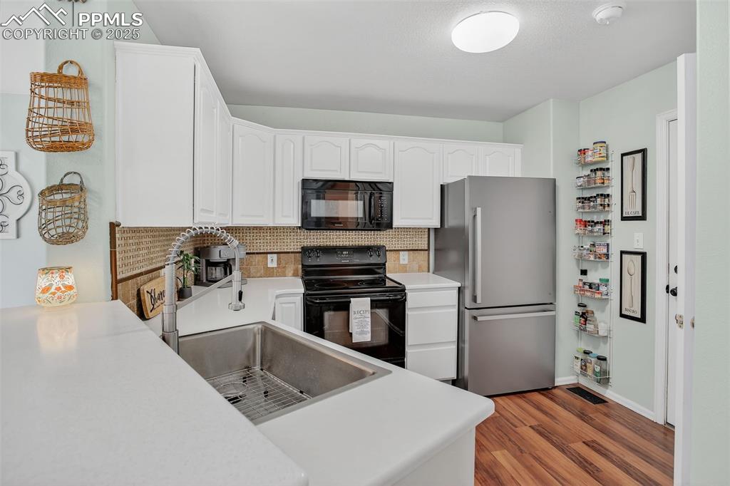 Inside, the bright and welcoming layout offers a cozy gas fireplace, an updated kitchen with new quartz countertops and sink, and a convenient main-level half bath.