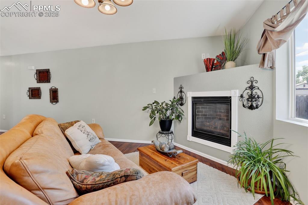 Inside, the bright and welcoming layout offers a cozy gas fireplace, an updated kitchen with new quartz countertops and sink, and a convenient main-level half bath.