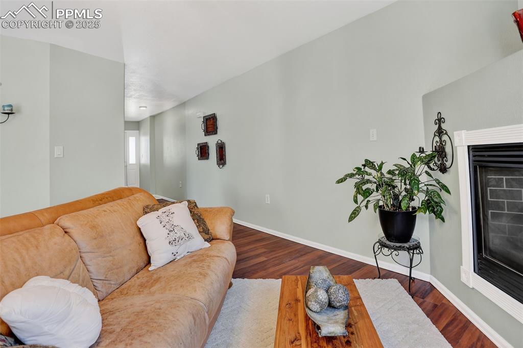 Inside, the bright and welcoming layout offers a cozy gas fireplace, an updated kitchen with new quartz countertops and sink, and a convenient main-level half bath.