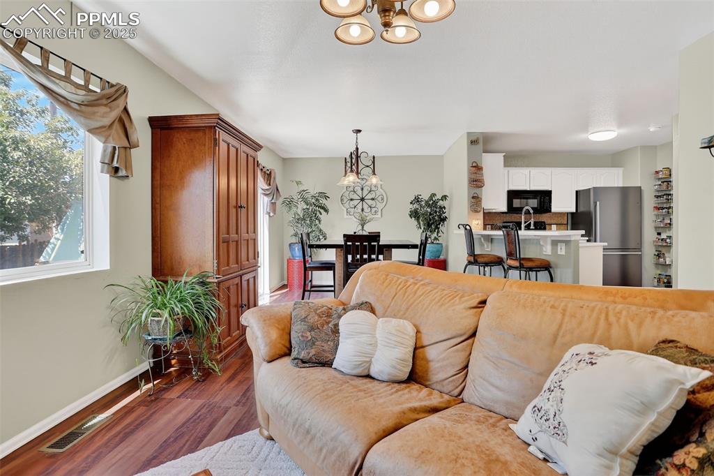 Inside, the bright and welcoming layout offers a cozy gas fireplace, an updated kitchen with new quartz countertops and sink, and a convenient main-level half bath.