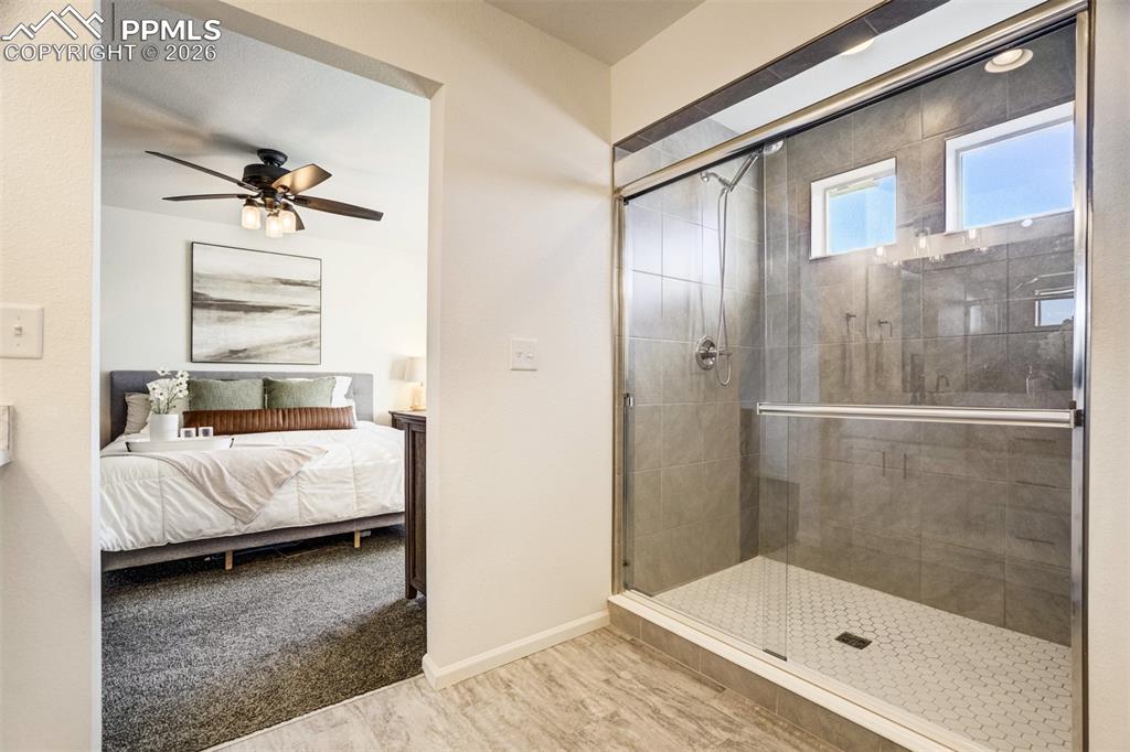 Oversized standing shower with windows & tile surround. 