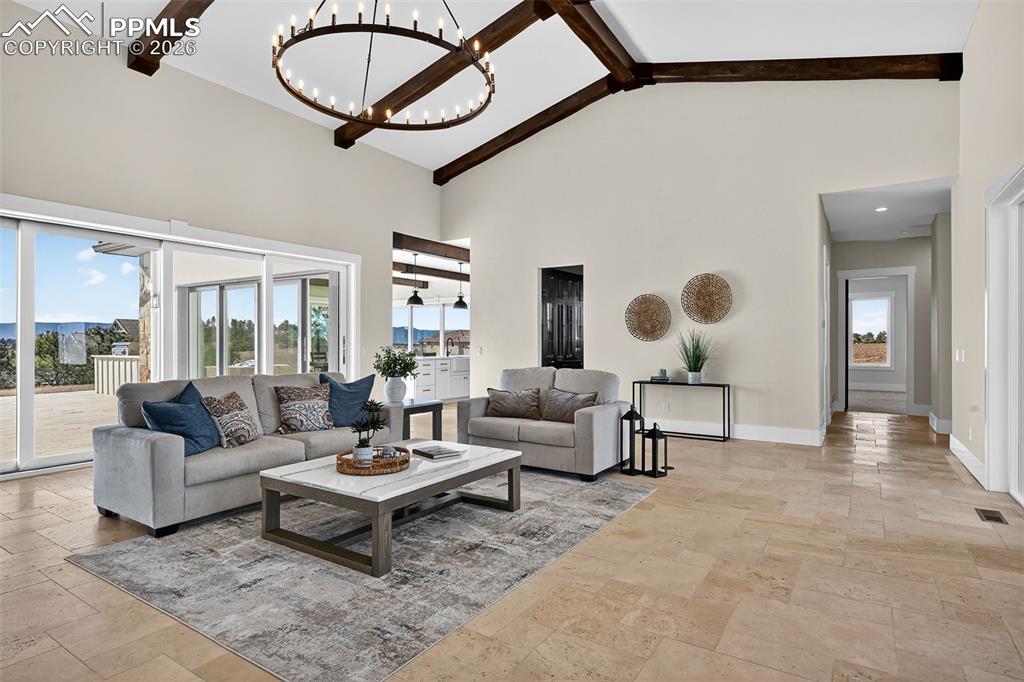 Living area with hanging lights and light stone finish flooring