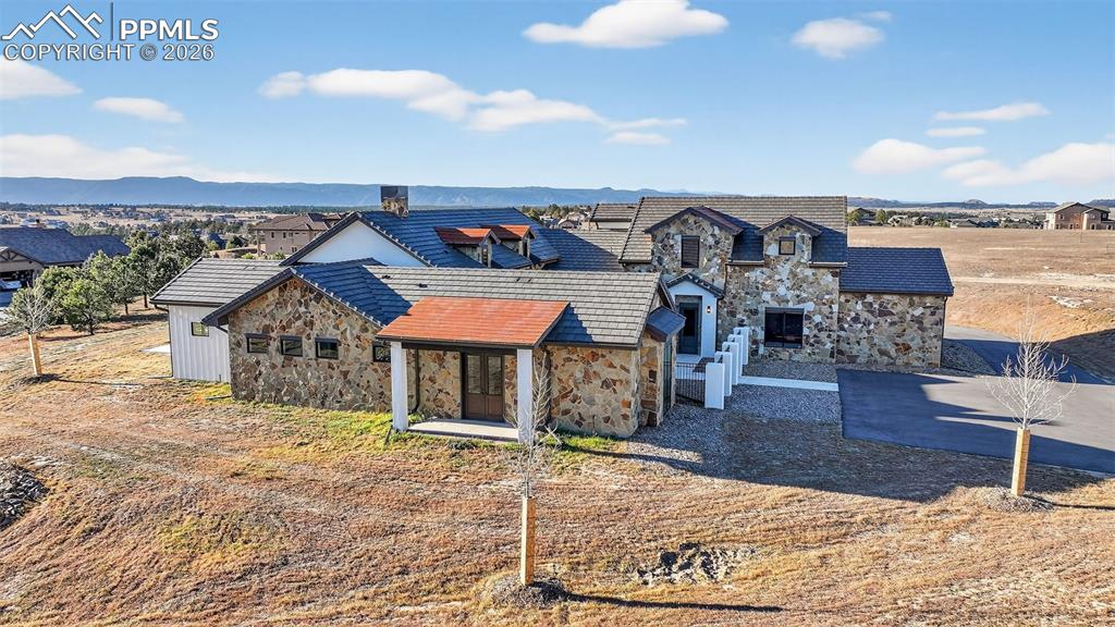 View of front facade with stone siding and a mountain view