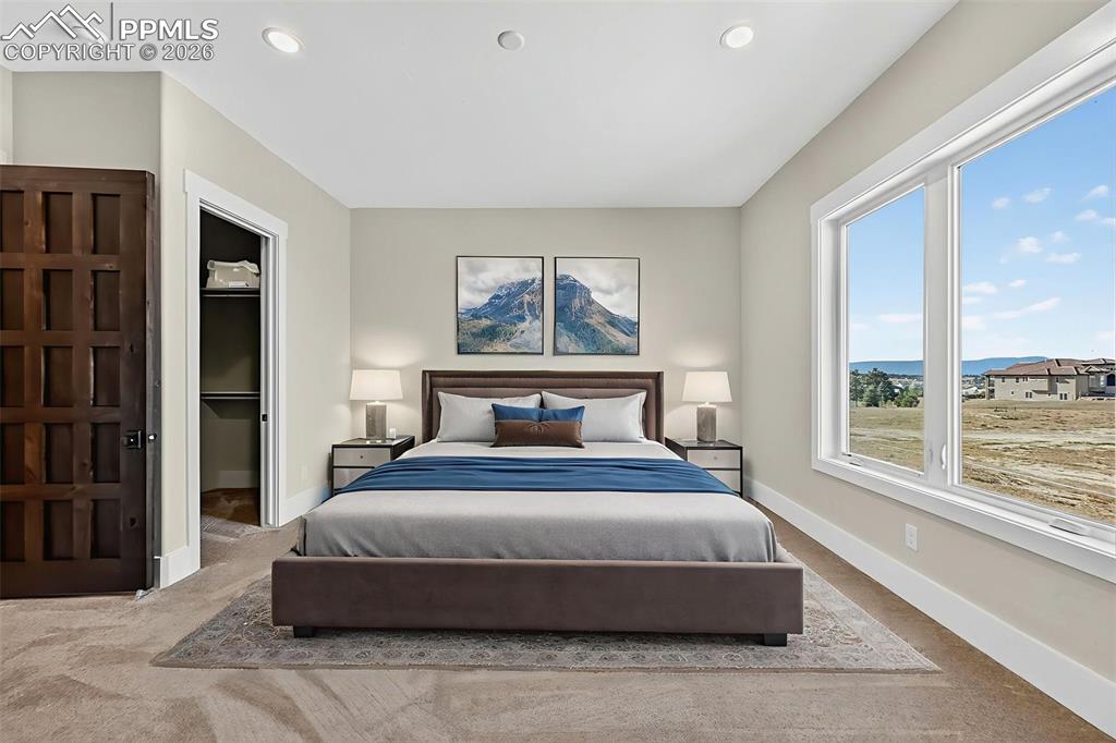 Bedroom with a walk in closet, carpet flooring, and recessed lighting