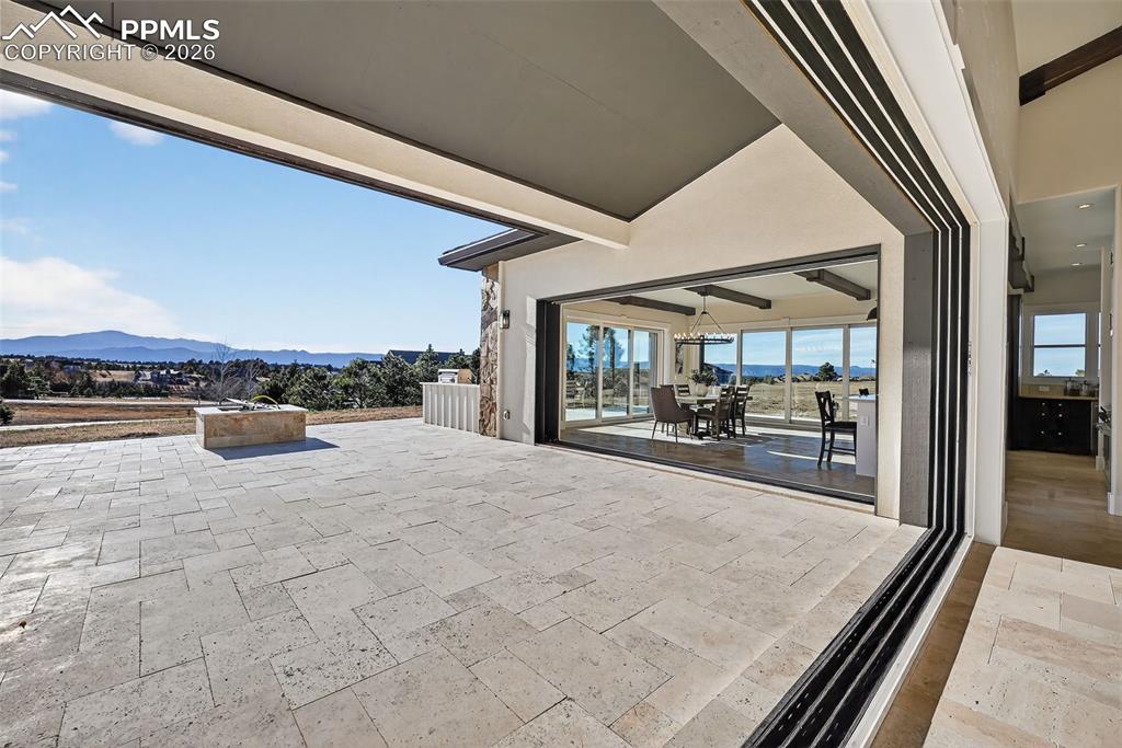 View of patio with a mountain view and outdoor dining space