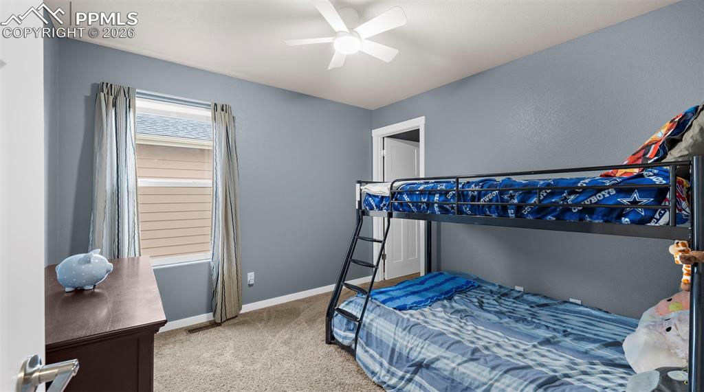 Bedroom featuring light carpet and ceiling fan