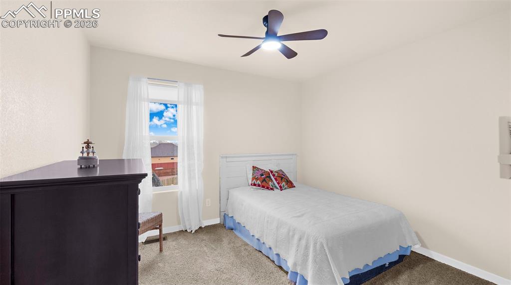 Bedroom featuring carpet flooring and a ceiling fan