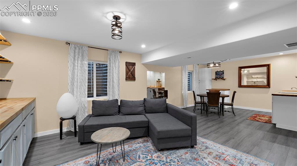 Living room featuring dark wood-type flooring and recessed lighting