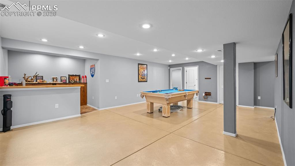 Rec room featuring billiards table, concrete floors, and recessed lighting