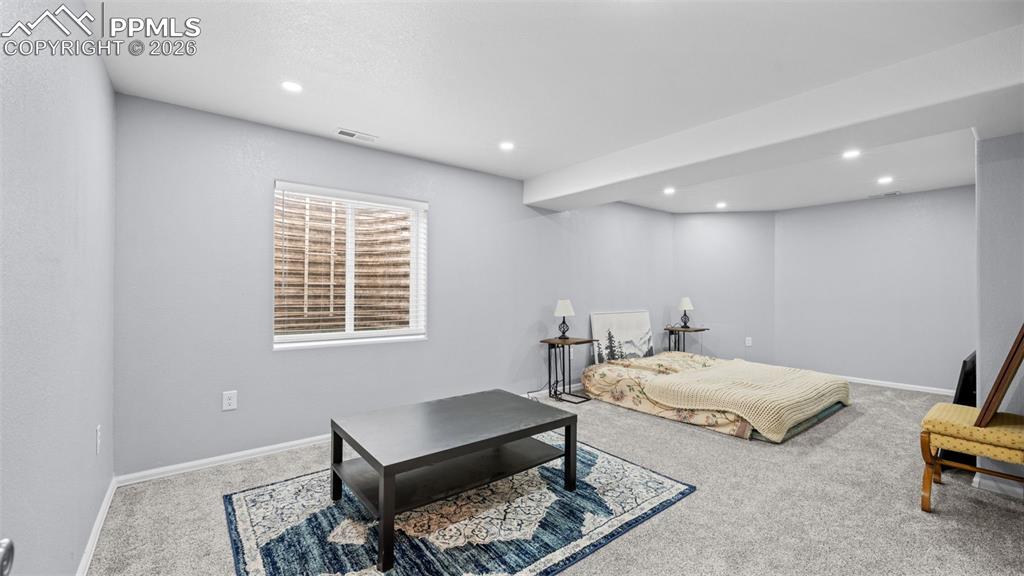 Bedroom featuring light carpet and recessed lighting