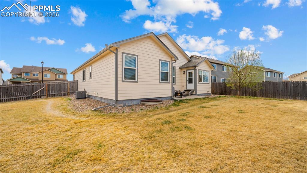 Rear view of house featuring a patio area and a fenced backyard