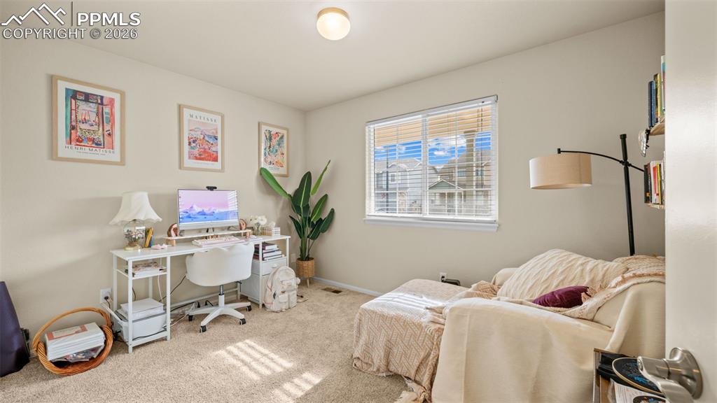 Office space with light carpet and baseboards