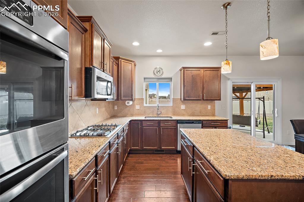 Lots of countertops for preparing your meals, gas cook top, double ovens!  This kitchen has it all.  