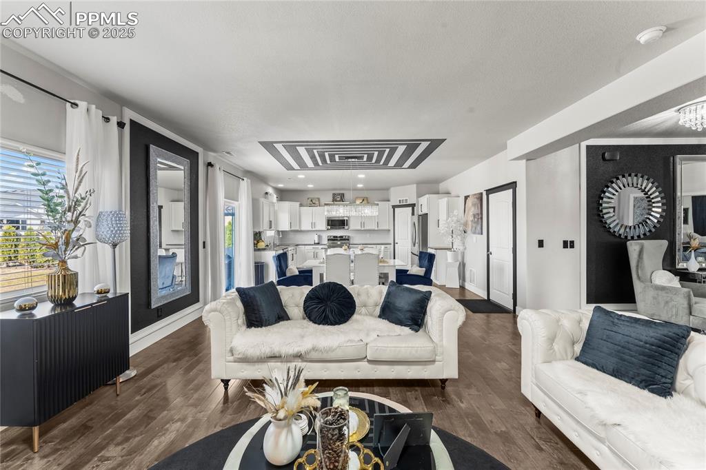 Living room with dark wood-style flooring and baseboards