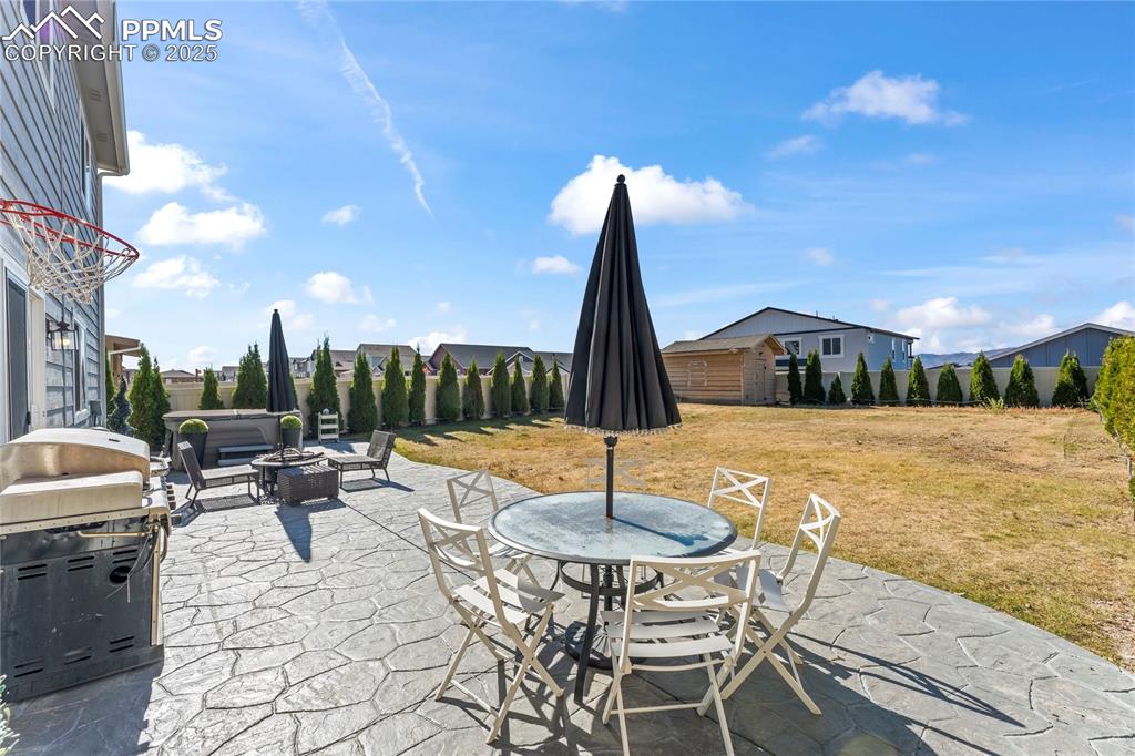 View of patio featuring an outdoor fire pit, outdoor dining space, and grilling area