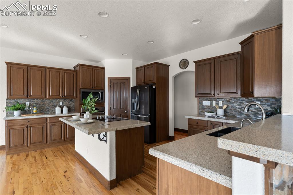 The kitchen has space to eat at multiple islands, a large pantry, solid surface counters, room to eat in - and is adjacent to multiple deck entries and the sunroom!  Slow close cabinetry, instant hot water - nothing missed here.