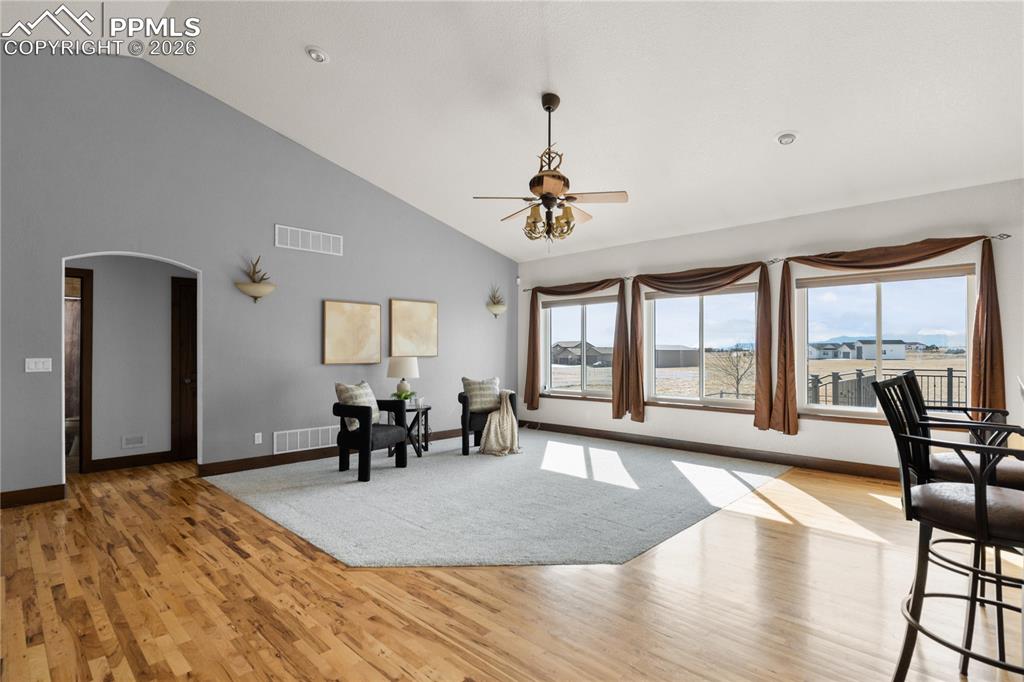 This living room has peak views, privacy on your acreage and a multi-sided fireplace to stay cozy.